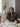 Black woman fashion designer smiling at workspace, representing women led sustainable fashion and ethical leadership